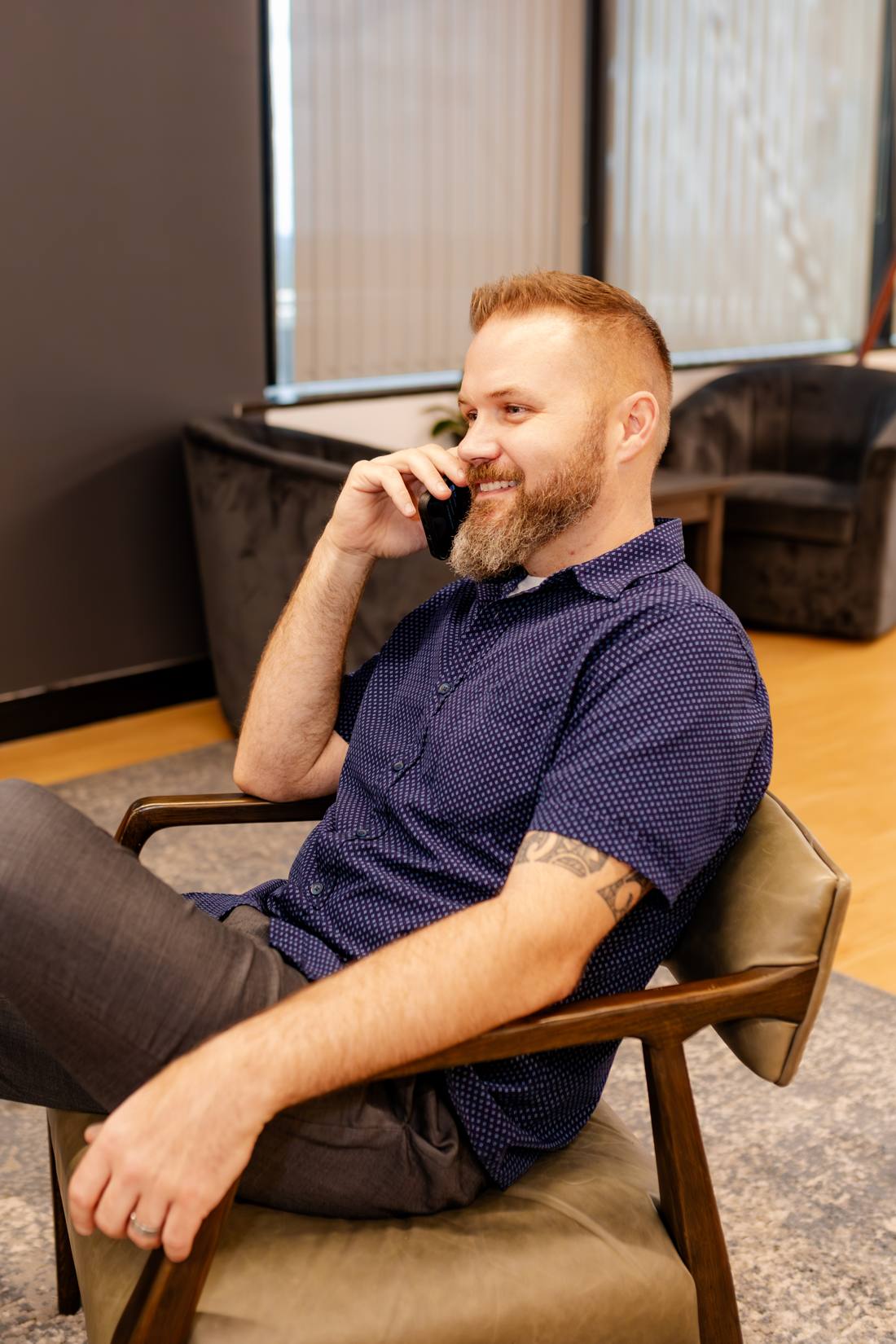 Matt Nelson taking a call in a relaxed San Antonio office lounge